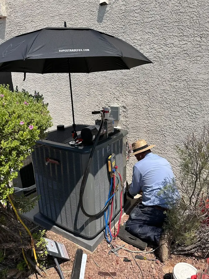 HVAC technician performing outdoor AC maintenance in Oviedo